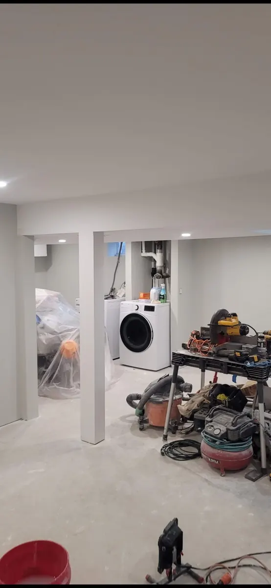 Freshly painted finished basement room with clean white walls