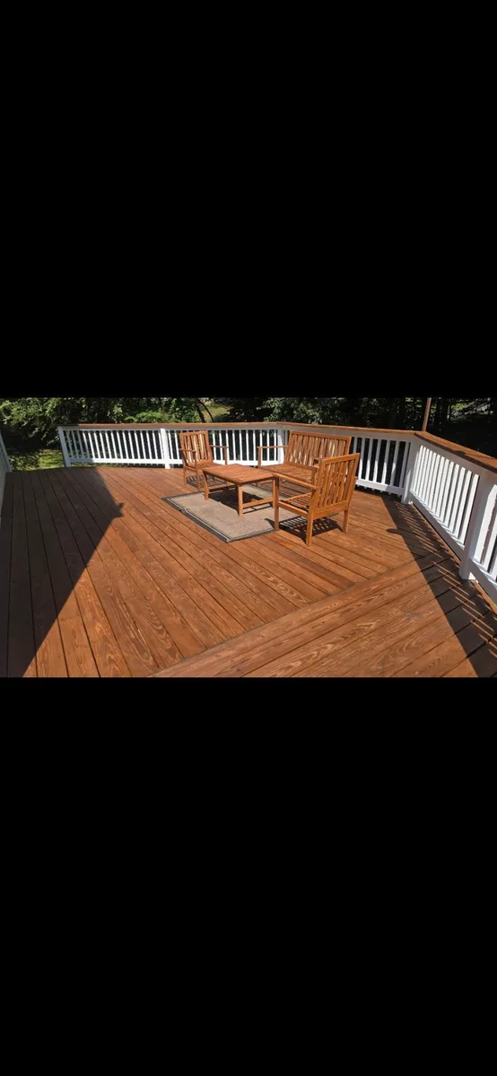 Warm brown stained deck with a refreshed white-and-wood railing