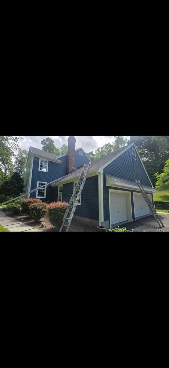 Deep navy home exterior with crisp white trim after repainting