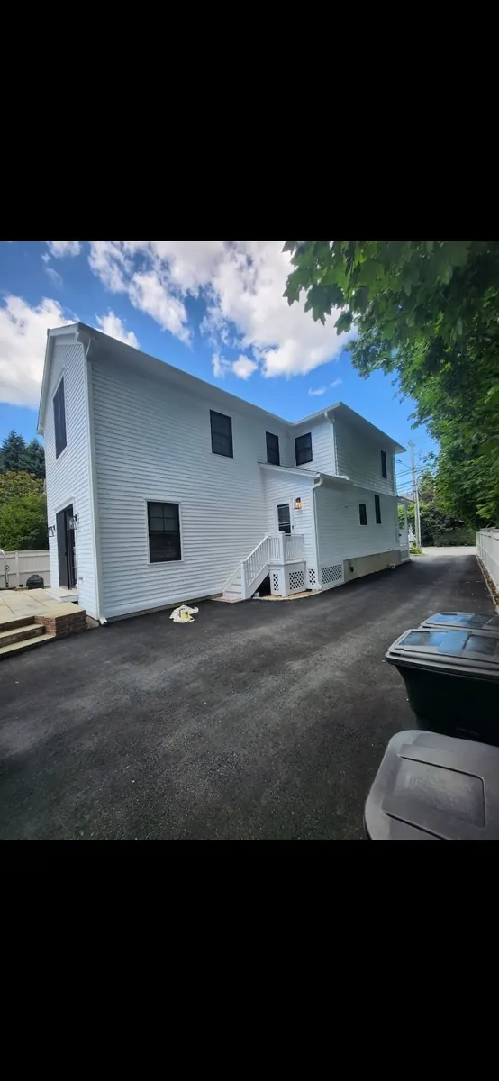Freshly painted white siding on a clean, finished home exterior
